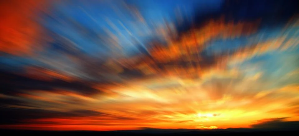 Blurred sunset with clouds Stock Photos