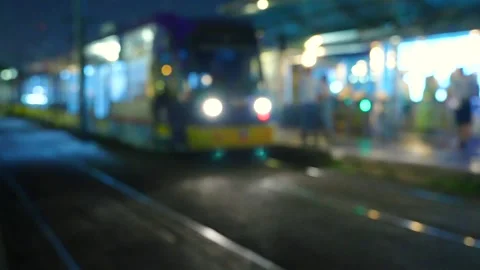 Blurred T1 Tram train on the line at night. Istanbul, Turkey. People returning Stock Footage 249640484