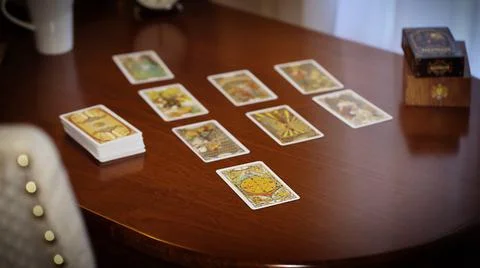 Blurred tarot cards on the table, esoteric concept, fortune telling predictio Stock Photos