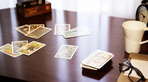 Blurred tarot cards on the table, esoteric concept, fortune telling predictio Stock Photos