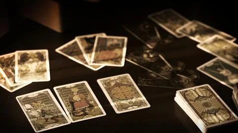 Blurred tarot cards on the table, esoteric concept, fortune telling predictio Stock Photos