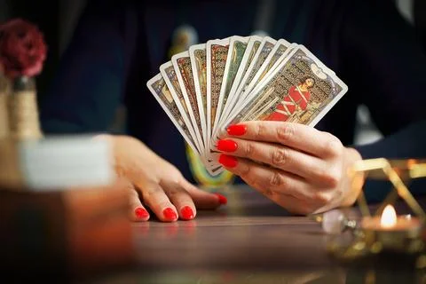 Blurred tarot cards on the table, esoteric concept, fortune telling predictio Stock Photos