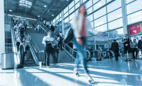 Blurred trade fair visitor using a skywalk/staircase Stock Photos