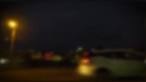 Blurred traffic at night on a busy road with lighted signs and a colorful sce Stock Footage 153440912