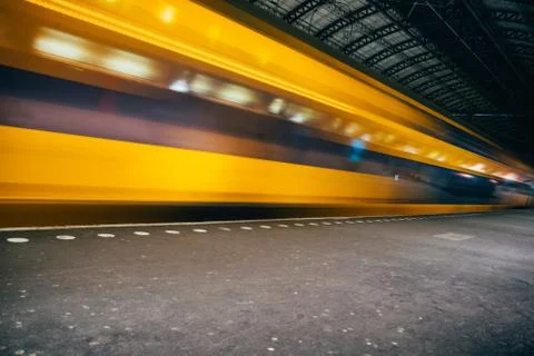 Blurred train motion with high speed at railway station Stock Photos