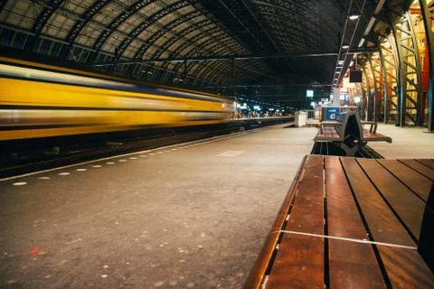 Blurred train motion with high speed at railway station Stock Photos