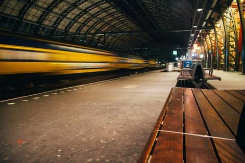 Blurred train motion with high speed at railway station Stock Photos