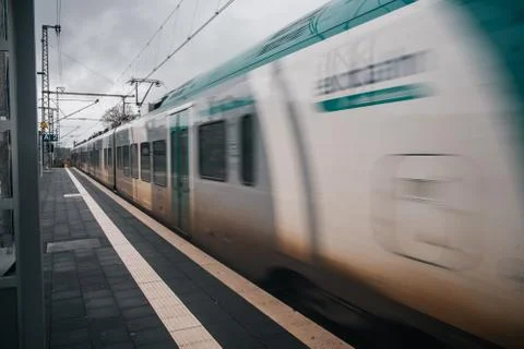 Blurred train motion with high speed at railway station Stock Photos