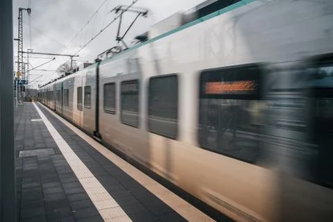 Blurred train motion with high speed at railway station Stock Photos