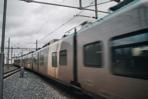 Blurred train motion with high speed at railway station Stock Photos