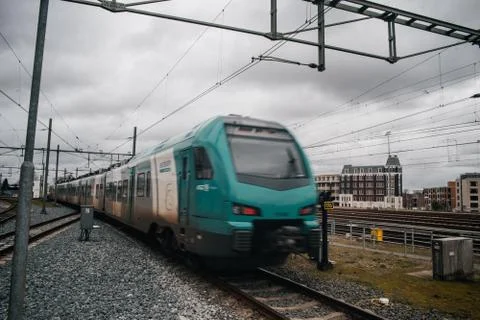 Blurred train motion with high speed at railway station Stock Photos