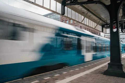 Blurred train motion with high speed at railway station Stock Photos