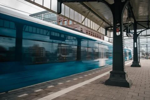 Blurred train motion with high speed at railway station Stock Photos