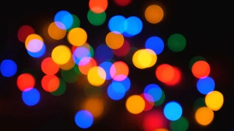 Blurred Twinkling Multi-Colored Holiday Lights On Black Background Stock Footage 93195643