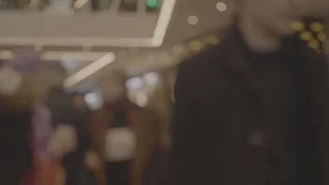 Blurred unrecognizable crowd of people walking at a shopping center in the Stock Footage 107180166