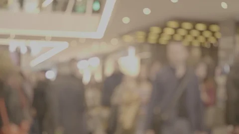 Blurred unrecognizable crowd of people walks at a mall in the business district Video stock 106804147