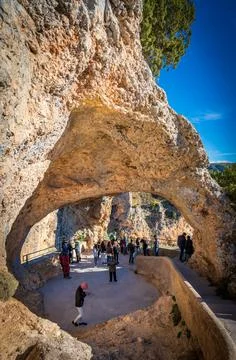 Blurred unrecognizable tourists visit devils window, Cuenca Stock Photos