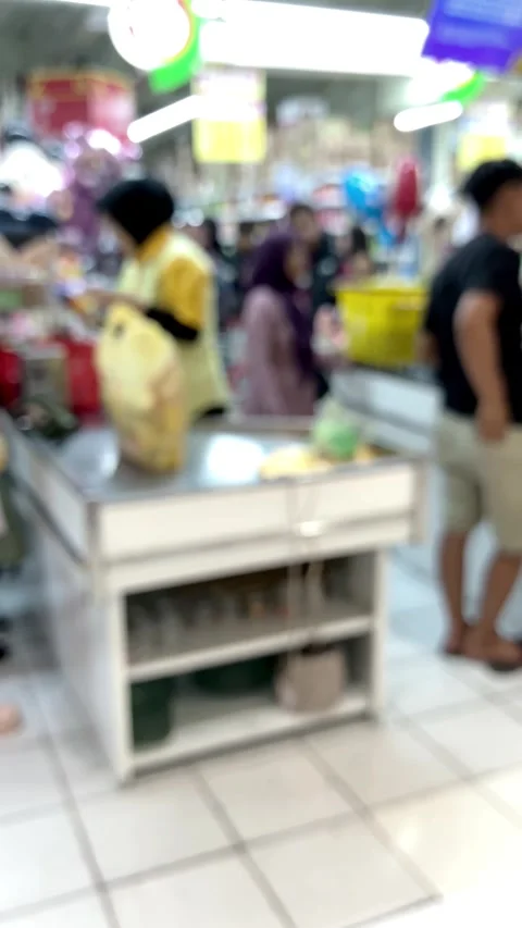 Blurred vertical view of customers paying at supermarket checkout counter. 스톡 동영상 341562225