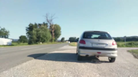 Blurred video of car parked by the side of the road Stock Footage 134658214