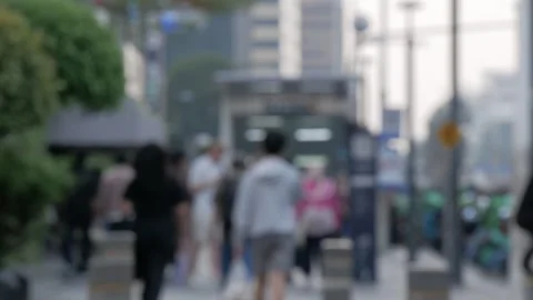 Blurred video of a crowd of unrecognized pedestrian walking on the sidewalk Stock Footage 309437153