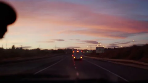 Blurred video of a road during a sunset while driving a car. Stock Footage 166831687