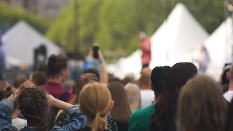 Blurred view of american people dancing and recording video at rock festival in Stock Footage 119906738