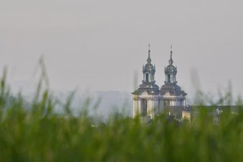 Blurred, the view from below through the grass to the old buildings with towe Stock Photos