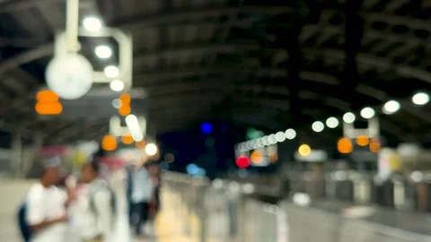 Blurred view of a bustling train station with glowing lights and people in .. Stock Footage 339296010
