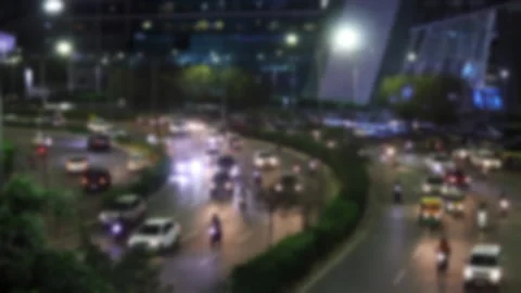 Blurred view of a busy evening road traffic in Gurgaon, India Stock Footage 295369424