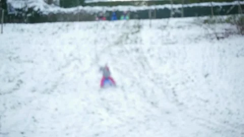 Blurred view of a child sledding on snowy mountain Stock Footage 146711271