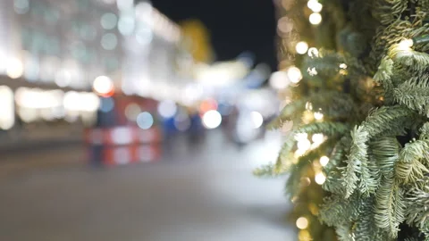 Blurred view of Christmas tree and street lights at night. Stock Footage 320228655
