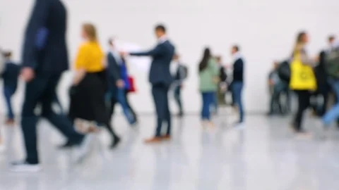 Blurred view of crowd of people with man holding a map Stock Footage 116026469