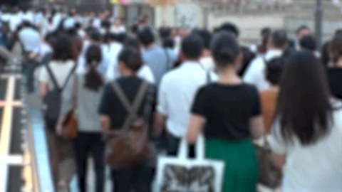 Blurred view of crowd of people walking down the street in busy rush hour. Stock Footage 114876867