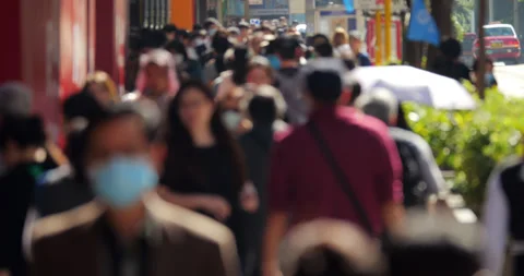 Blurred view of crowd walking on Nathan Road sidewalk in Hong Kong Stock Footage 309399973