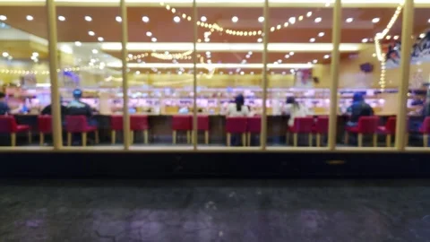 Blurred view of customers dining at a modern restaurant counter with red ch.. Video stock 344029655