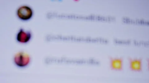 A blurred view of a device screen displaying the livestream comment panel. Users Stock-Footage 330607306