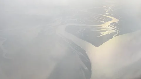 Blurred view of earth surface with river from frozen porthole of plane above Stock Footage 280271332