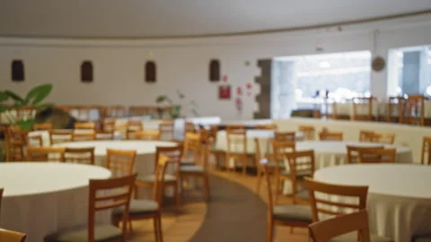 Blurred view of an empty wedding hall with tables and chairs set for an eve.. Stock Footage 303030476