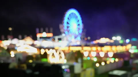 Blurred View of Ferris Wheel Attraction at Night in Amusement Park Stock Footage 198346994