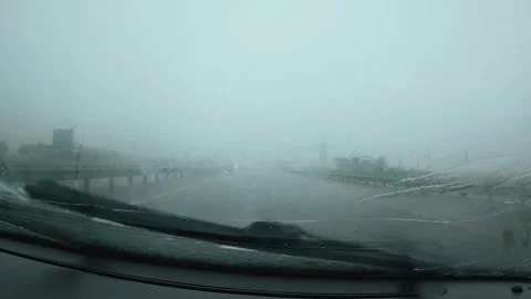 A blurred view from inside a car during heavy rain, when streaks of water make 動画素材 315185999