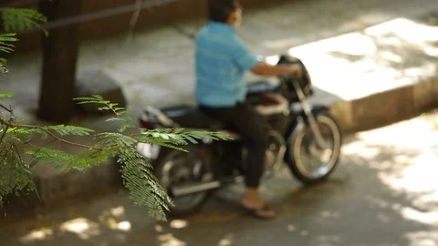 Blurred view of a man on a motorcycle 스톡 동영상 129740943