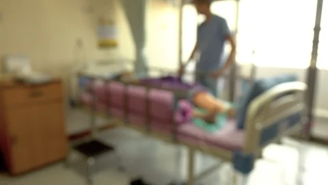 Blurred view of a man visiting senior woman patient in hospital bed Stock Footage 111302226