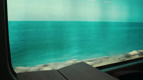 Blurred view of the ocean from a train window in Italy Stockbeeldmateriaal 340272814