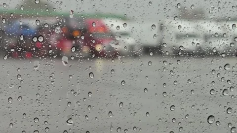 Blurred view of parked trucks through a rain-soaked windshield Stock Footage 281764171
