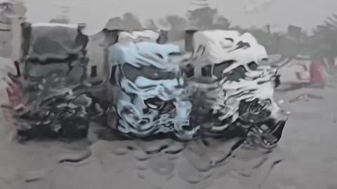 Blurred view of parked trucks through a rain-soaked windshield Stock Footage 281764184