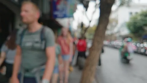 Blurred view of people walking along a bustling city street sidewalk. 库存影片 343370507