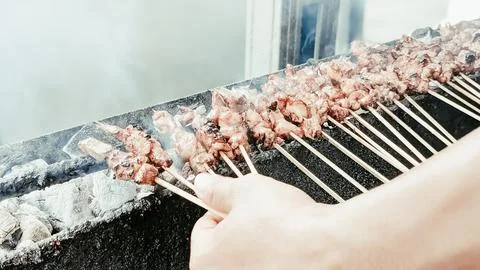 Blurred view. The serving process of satay. Stock Photos