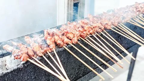 Blurred view. The serving process of satay Stock Photos