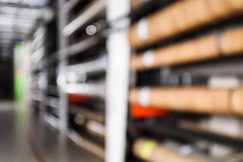 Blurred view of storage stands with different building materials in wholesale Fotos de archivo