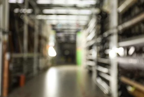 Blurred view of storage stands with different building materials in wholesale Fotos de archivo